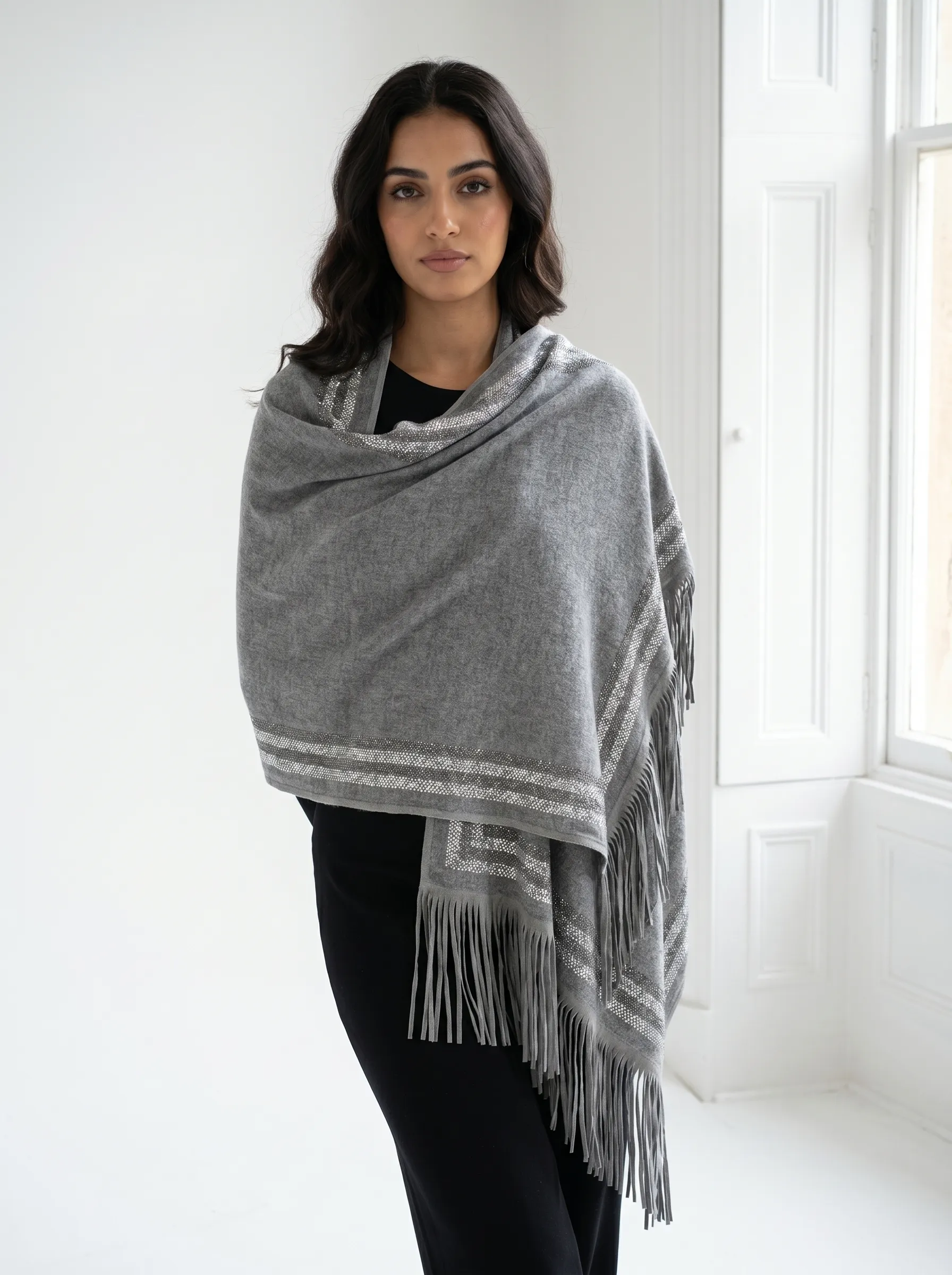 Pure Cashmere Fabric – Crafted from premium-grade cashmere, offering exceptional softness, warmth, and lightweight comfort Swarovski Embellishment – Delicately adorned with subtle Swarovski crystal detailing for an elegant, refined shimmer Suede Fringe Finish – Finished with rich suede fringes, adding texture and a sophisticated edge Generous Size – Measures 200 x 70 cm, perfect for versatile styling as a wrap, stole, or shawl Timeless Neutral Tone – A classic earthy shade that complements both formal and casual ensembles Artisan Craftsmanship – Expertly finished to ensure durability and a luxurious drape